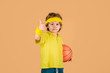 © Svitlana - Active lifestyle. Basketball game. Boy with basketball ball. Sport boy shows thumb up. Child holds ball. Sport game. Kid activities. Little basketballer. Sports equipment. Thumbs up.