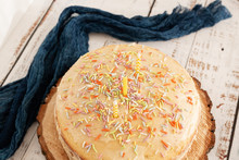 Whole Vanilla Cake With Sprinkles And Three Yellow Candles