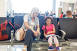 © Angelov - Mom and child are waiting for their plane at the airport. Passengers are waiting for their transport in the station
