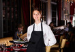 © JackF - Female waiter standing with serving tray, recommending dishes in restaurant