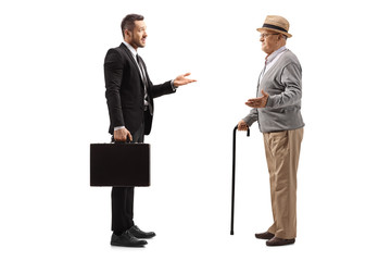 Poster - Businessman with a suitcase having a conversation with an elderly gentleman