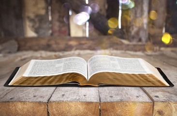 Wall Mural - open book on old wooden table.