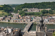 Dinant, Belgium - June 26, 2019: Seen from Citadelle. Large building on top is College Notre Dame de Bellevue, school system from primary to high school. Forests in back. City, river and church