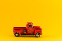 Red Toy Truck On Bright Yellow Background