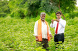 © Niks Ads - Indian farmer Discussing with agronomist at Farm and collecting some information