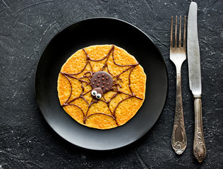 Canvas Print - Halloween pumpkin pancake with chocolate spider for funny kids breakfast