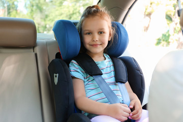 Canvas Print - Little girl buckled in car safety seat