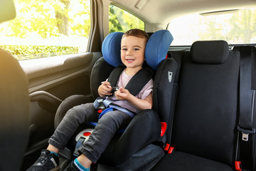 Baby boy buckled in car seat