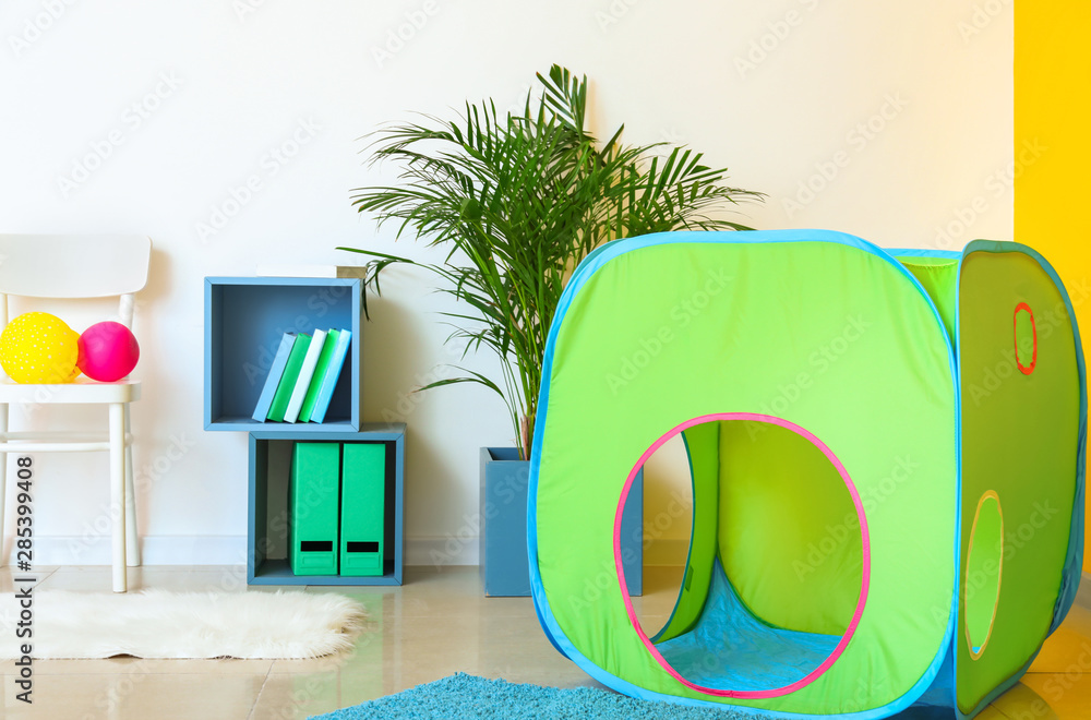 Interior of modern children's room with play tunnel