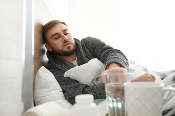 Poster - Man ill with flu lying in bed