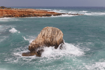 Rocky shore of Cyprus with waves crashing