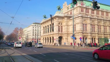 Canvas Print - VIENNA, AUSTRIA - FEBRUARY 18, 2019: The traffic in busy Ringstrasse avenue with a view on splendid Wiener Staatsoper - the State Opera theatre, on February 18 in Vienna.