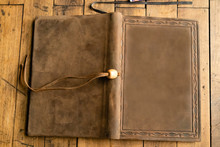 Old Leather Bound Book With Bookmark And A Blank Cover,  On A Wooden Table