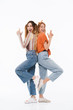 © Drobot Dean - Photo of two teen girls wearing colorful clothes standing back to back and doing gun gesture with fingers