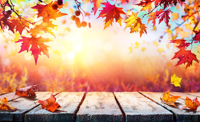 autumn backdrop - wooden table with red leaves