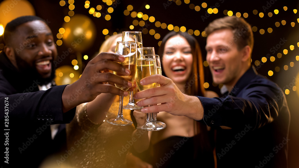 Cheerful multi-racial friends clinking champagne glasses, corporate event, fun - obrazy, fototapety, plakaty 