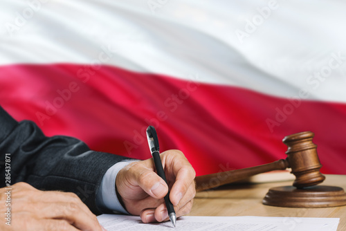 Fotomural Judge writing on paper in courtroom with Poland flag background