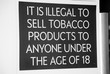 A tobacco products age restriction sign at a UK store.