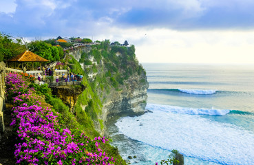 seascape, ocean at sunset. ocean coast with waves near uluwatu temple at sunset, bali, indonesia.