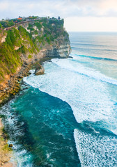 Wall Mural - Seascape, ocean at sunset. Ocean coast with waves near Uluwatu temple at sunset, Bali, Indonesia.