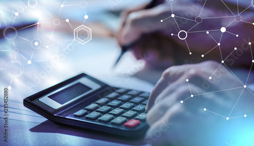Cuadros en Lienzo Hand using calculator, accounting concept; light effect