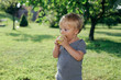 © cherryandbees - cute little boy eating apple outdoor