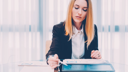 Wall Mural - Successful career. Portrait of confident business woman working at modern office, reviewing report.