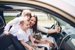 © Олег Кошевський - Mother with two children and a dog traveling by car