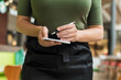© flowertiare - Cropped image of woman waitress in apron ready to take order using notepad and pen in cafe or restaurant.