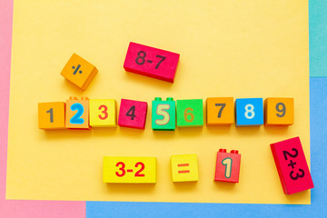 Wall Mural - child kid colorful education toys cubes with numbers math pattern background on the bright background. Flat lay. Childhood infancy children babies concept.