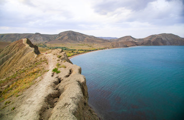 Wall Mural - The black sea coast in the Crimea, in Koktebel on the Cape Chameleon at sunset