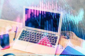 Multi exposure of graph and financial info and work space with computer background. Concept of international online trading.