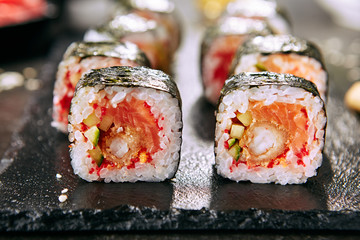 Canvas Print - Hot Spicy Uramaki Sushi Rolls in Japanese Restaurant Closeup