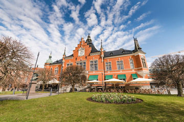 Umeå Town Hall, the main facade facing south, the side view photo from the right side. The spring time, sunny day with blue skies, trees have no leaves yet