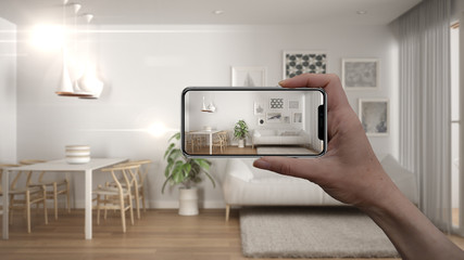Wall Mural - hand holding smart phone, ar application, simulate furniture and interior design products in real ho