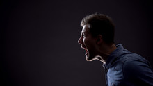 Frustrated Man Emotionally Screaming Isolated On Black Background, Life Problems