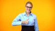 © motortion - Attractive office manager showing thumbs up, business project approval, idea