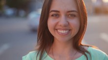 Young Happy Brunette Girl Looking, Smiling And Posing To Camera On The Parking Near The Mall At Sunset In A Summer Day, Slow Motion