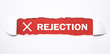 Rejection word on torn paper.