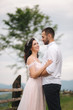© Aleksandr - Lovestory of beautiful couple in the mountains, Handsome bearded man with beautiful and charming woman. Couple stand in front of beautiful tree