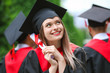 © Pixel-Shot - Female student in bachelor robe and with diploma outdoors