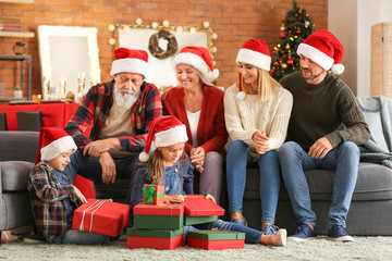 Wall Mural - Little children with their family opening Christmas gifts at home