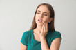 © Pixel-Shot - Young woman suffering from toothache against light background