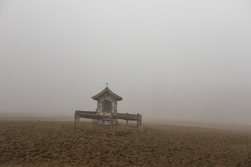 the old chapel in a fog alps, austria