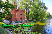 Historic Water Pumping Station And Boats On The Lake In Royal Wilanow Park In Warsaw, Poland. August 2019