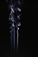 White wavy smoke on black background