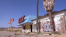 A Spooky Old Abandoned Gas Station And Restaurant In Ruins In The Mojave Desert.