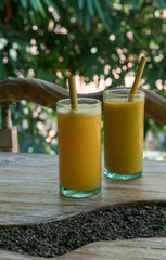 Zero waste concept with reuse bomboo straw, tropical delicious juice, Thai Bali seasonal, cool ice beverage for refreshing in summer on green nature bokeh background