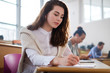 © Nejron Photo - Beautiful girl taking notes in multinational group of students in an auditorium