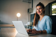 © bnenin - Portrait of a smiling female student with laptop indoors.